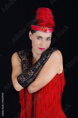 Poster Young beautiful brunette in 1920 style attire red dress and a fe