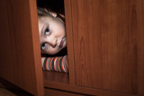 Fototapeta Młodzieżowe - Scared child hiding