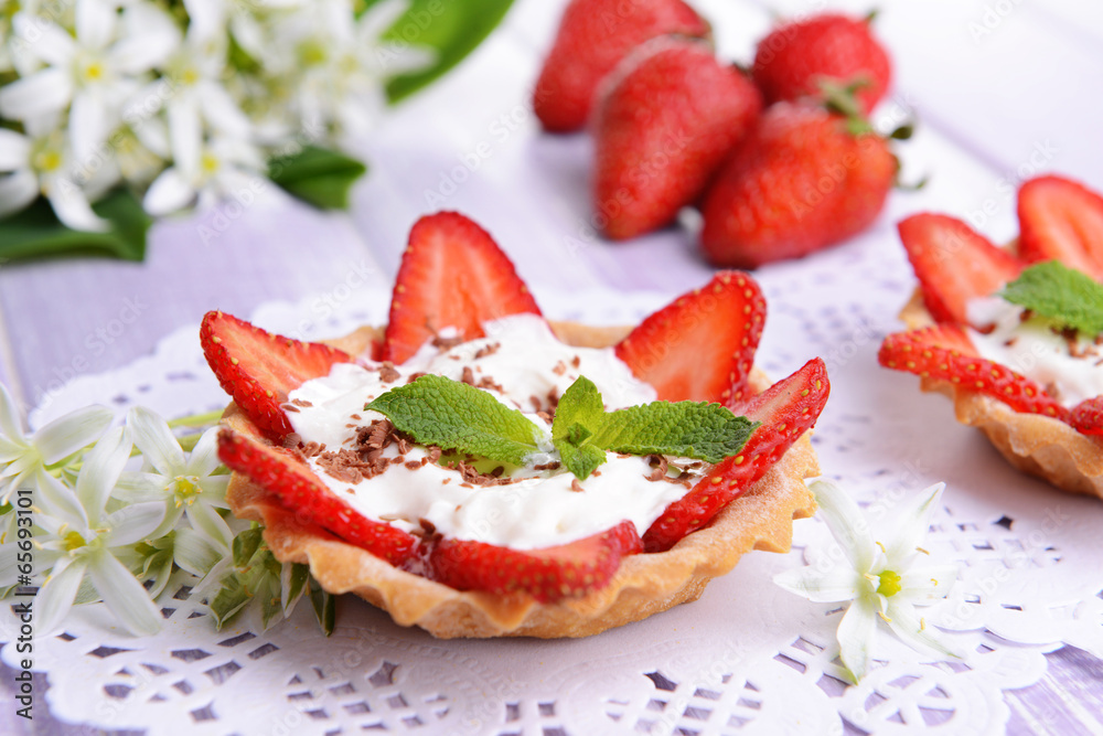Tasty tartlets with strawberries on table close-up