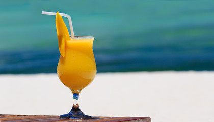 Wall Mural - mango cocktail on tropical beach