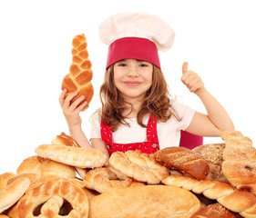 Wall Mural - happy little girl cook with breads rolls and thumb up