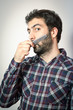 © simonekesh - young man want comb his beard and moustaches