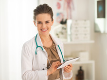 Smiling Medical Doctor Woman Using Tablet Pc