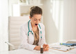 Medical doctor woman yawning in office