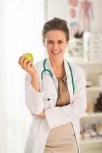 Smiling Medical Doctor Woman With Apple