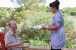 © godfer - carer giving senior food in residential home
