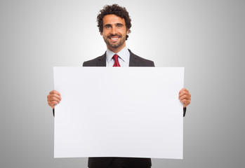man holding a blank board.