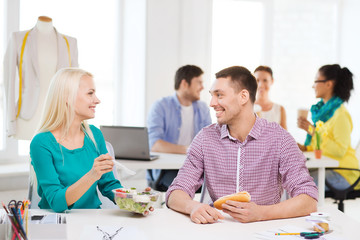 Poster - smiling fashion designers having lunch at office