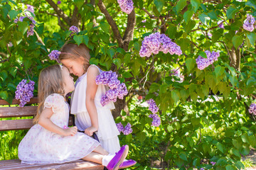 Wall Mural - Little cute girl enjoy spring day in beautiful blooming garden