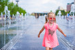 © travnikovstudio - Little adorable girl have fun in street fountain