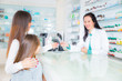 © Mediteraneo - pharmacist  giving vitamins to child girl in pharmacy drugstore