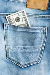 Canvas Print - U.S. dollars in the back jeans pocket