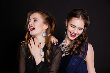 portrait of two beautiful young women with perfect makeup and