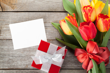 Fresh colorful tulips with gift box and greeting card