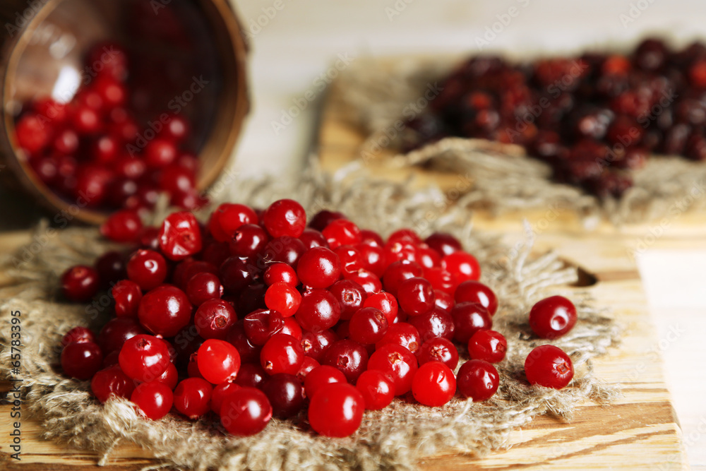 Fresh and dry cranberry on wooden table close-up