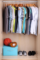 Colorful clothes hanging in wardrobe