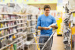 © michaeljung - young man shopping at hardware store