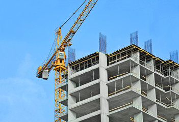 crane and building construction site against blue sky