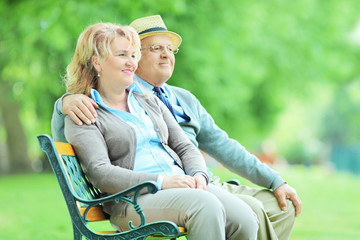 Sticker - Mature couple sitting on a bench in park