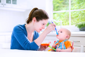 Wall Mural - Baby boy eating his first solid food