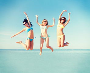 girls jumping on the beach