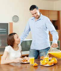 Wall Mural - couple having breakfast  in morning at home