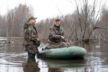 The Hunters Put Stuffed Ducks On Water From A Rubber Boat