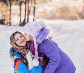 Happy family playing in winter outdoors