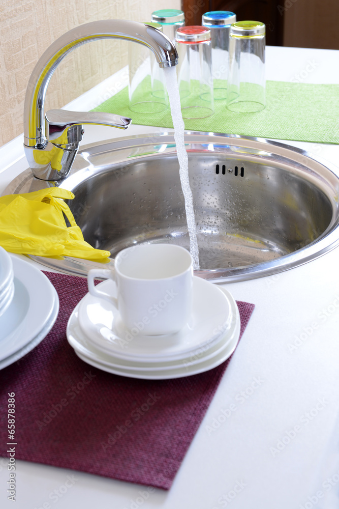 Dishes drying near  metal sink