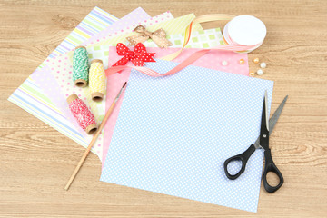 Paper for scrapbooking and tools, on wooden table