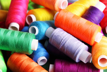 Multicolor Sewing Threads On Wooden Background