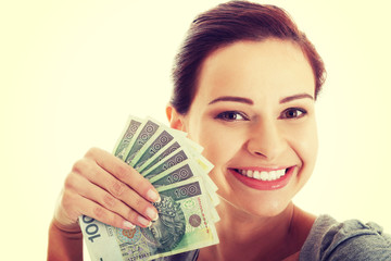 Beautiful casual woman holding money.