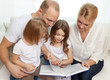 © Syda Productions - smiling family and two little girls with book
