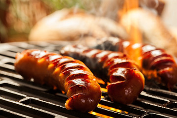 Wall Mural - Grilling sausages on barbecue grill