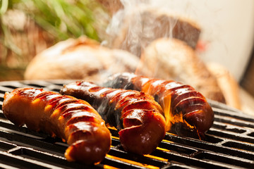 Wall Mural - Grilling sausages on barbecue grill