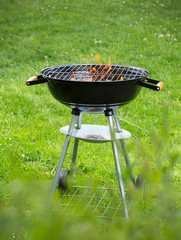 Empty burning grill on garden