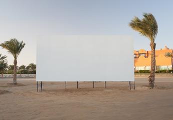 Blank billboard with palm trees