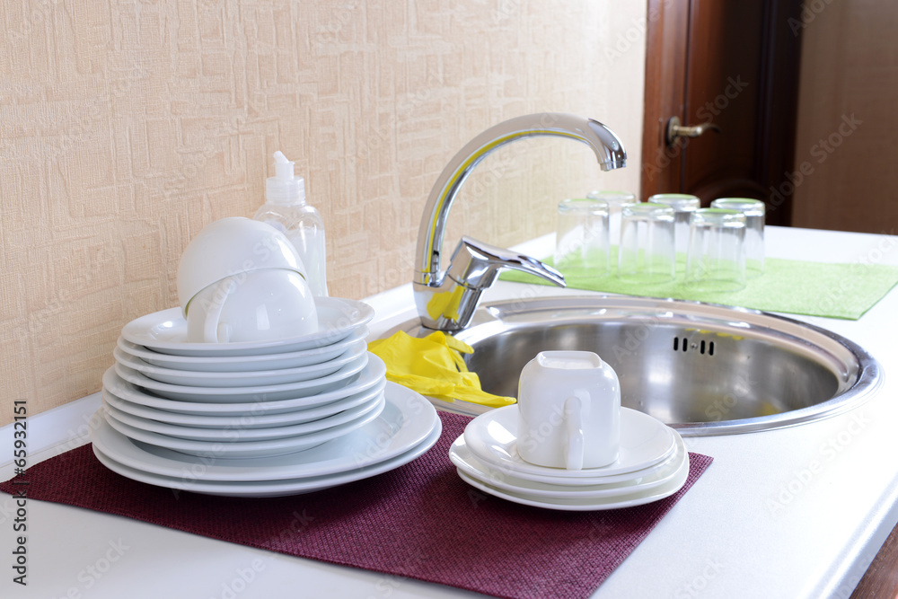 Dishes drying near  metal sink