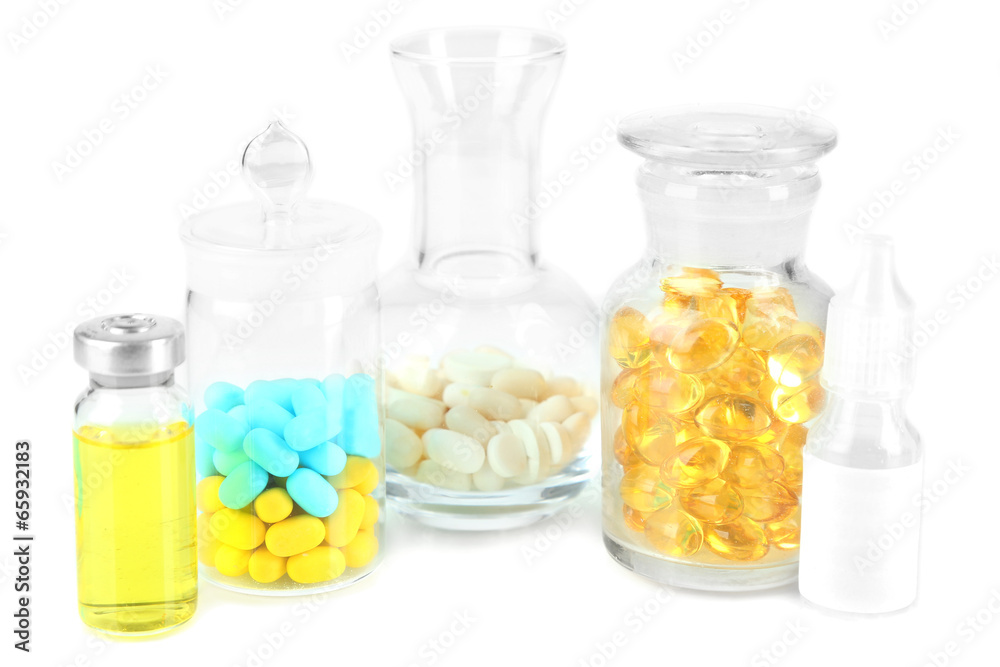 Medical bottles and pills isolated on white