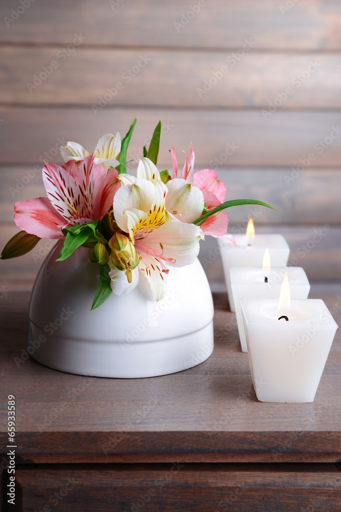 Alstroemeria flowers in vase on table on grey background