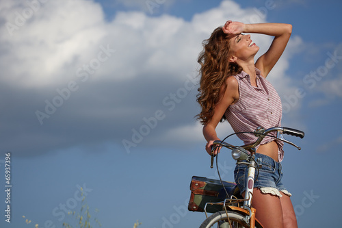 Plakat na zamówienie beautiful sexy girl next to the bike