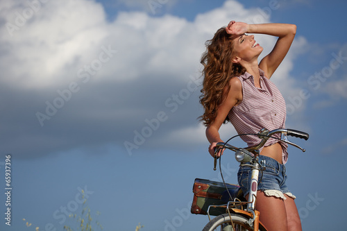 Obraz w ramie beautiful sexy girl next to the bike