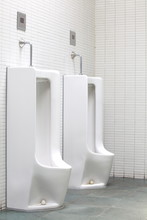 Empty White Men Toilet At Pubic Restroom