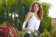 © ZoomTeam - Pretty young woman rwith old bike in a country road.