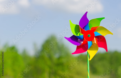 Fotografia, Obraz Childish pinwheel against blue sky background.