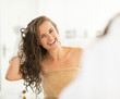 © Alliance - Portrait of smiling young woman wiping hair with towel
