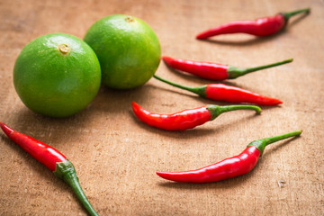 Chili and lime on wooden table, Asian herb and spicy