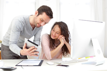 Wall Mural - Man working on tablet with his co-worker