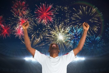 Sticker - Composite image of excited handsome football fan cheering