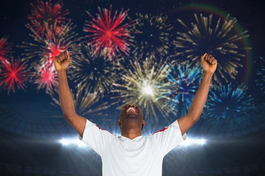 Composite image of excited handsome football fan cheering